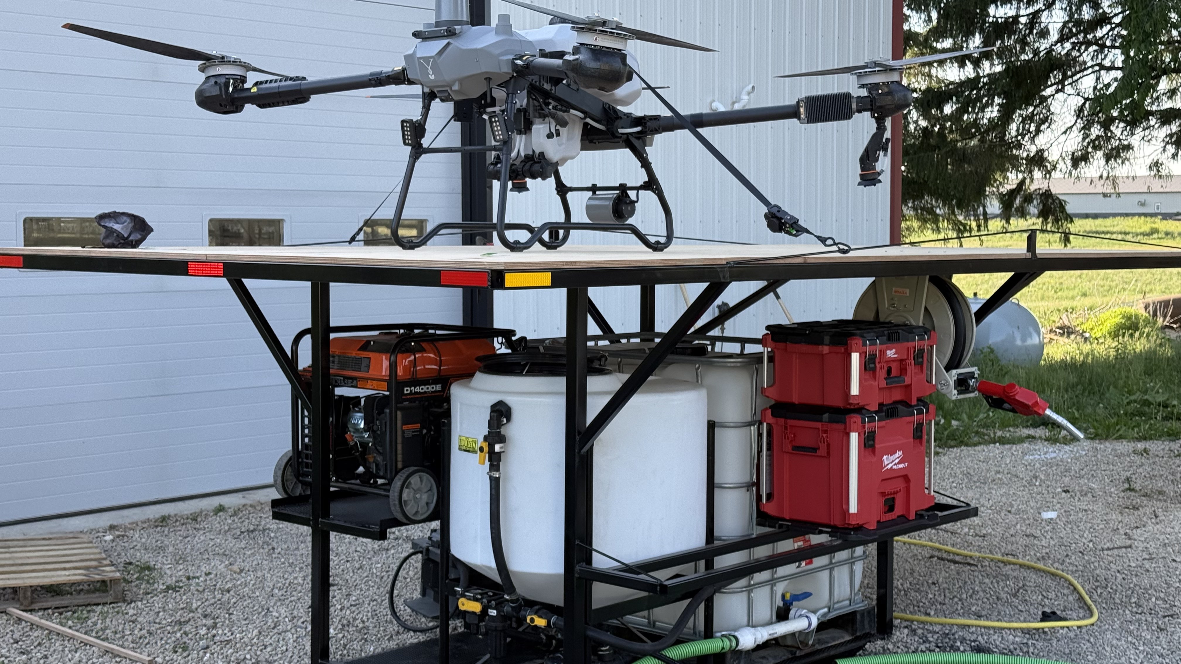 Truck-bed skid with Talos T60X drone, mixing tanks, generator, and pump — SkyLand Drone LLC field setup